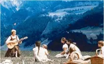  ??  ?? Julie Andrews as Maria sings with the children against a backdrop of the Alpine mountains.