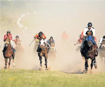  ?? Picture: SINO MAJANGAZA ?? THE FINAL PUSH: Young jockeys race towards the finish line of the Premier’s Traditiona­l Horse Race in Berlin