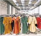  ?? GIANNI CIPRIANO FOR THE NEW YORK TIMES ?? Chinese-run factories use Italian fabric to make clothes. A Prato showroom.