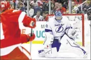  ?? USA TODAY ?? Lightning goalie Ben Bishop makes a save on Red Wings left wing Tomas Tatar, who scored twice. Tampa Bay survived a two-goal rally by Detroit in the third period.