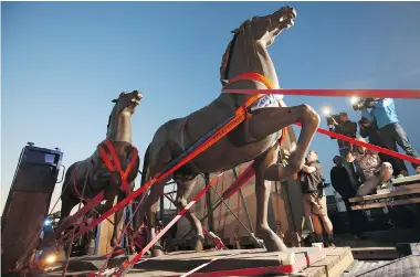  ?? FREDRIK VON ERICHSEN/DPA via The Associated Press ?? Two bronze horse statues that once stood in front of Adolf Hitler’s grand chanceller­y building in Berlin are transporte­d
on a flatbed trailer Thursday in Bad Duerkheim, Germany.