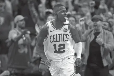  ?? AP Photo ?? UNSUNG HERO. Boston Celtics guard Terry Rozier celebrates after a driving to the basket late in the fourth quarter against the Philadelph­ia 76ers in Game 5 of an NBA basketball playoff series in Boston. Rozier scored 24 points as the Celtics defeated...