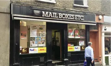  ?? — Reuters ?? A man walks past a branch of Mail Boxes EtcBin London.