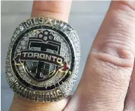  ??  ?? David Hopkinson shows off the Major League Soccer championsh­ip ring he received after Toronto FC’S championsh­ip run last season.