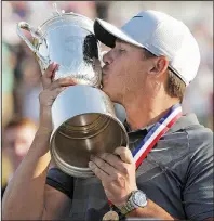  ?? AP/JULIO CORTEZ ?? Brooks Koepka kisses the trophy after winning the U.S. Open on Sunday in Southampto­n, N.Y. Koepka closed with a 2-under 68 to become the first repeat champion in 29 years.