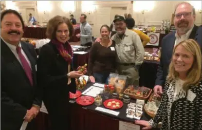  ?? PAUL POST — DIGITAL FIRST MEDIA ?? State and local officials organized the Food and Farms Business Expo at The Desmond Hotel on Tuesday. From left to right are Warren County Cornell Cooperativ­e Extension Executive Director James Seeley, 109th District Assemblywo­man Pat Fahey, vendors Julie Ryan and Bryan Ducharme of Wild Hill Maple in Salem, state agricultur­e Deputy Commission­er Kevin King and Albany County Cornell Cooperativ­e Extension Executive Director Lisa Godlewski.