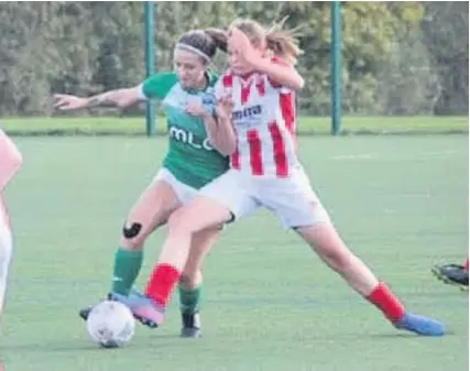  ??  ?? An Almondsbur­y player (green shirt) battles for the ball against Cheltenham Ladies Developmen­t