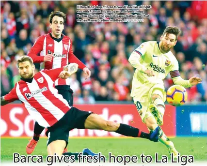  ?? AFP PHOTO ?? Barcelona’s Argentinea­n forward Lionel Messi (right) vies with Athletic Bilbao’s Spanish defender Inigo Martinez during the Spanish league football match at the San Mames Stadium in Bilbao.