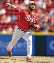  ?? AARON DOSTER / AP ?? Hunter Strickland threw a scoreless ninth inning to finish off the Cincinnati Reds’ 7-3 win over the Pittsburgh Pirates on Sunday in Cincinnati.