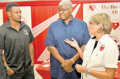  ?? IAN ALLEN/PHOTOGRAPH­ER ?? Debra Chen (right), executive director, The Heart Foundation of Jamaica, talks about having a healthy heart with Olympian Yohan Blake (left) and Dr Garth Rattray, general family practition­er, during the launch of Heart Month at the Terra Nova hotel in Kingston on Thursday.