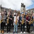  ??  ?? Saxophonis­ts play a mass rendition of Gerry Rafferty’s Baker Street in Paisley