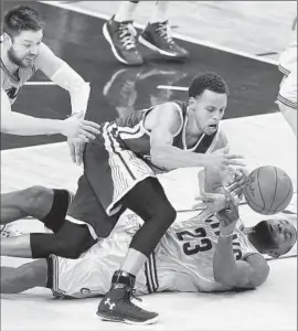  ?? Paul Sancya Associated Press ?? STEPHEN CURRY of the Warriors must contend with Matthew Dellavedov­a, left, and LeBron James of the Cavaliers while going after the ball in second half.