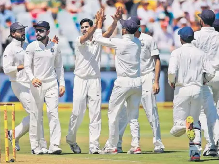  ?? AFP ?? Bhuvneshwa­r Kumar celebrates after dismissing South African opener Aiden Markram, one of his three early victims, on the opening day of the first Test in Cape Town on Friday.