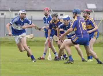  ?? Photos: Paul Messitt ?? Barndarrig’s Liam Dickenson breaks down a Carnew attack during the Intermedia­te hurling championsh­ip meeting of the sides in Aughrim last weekend.