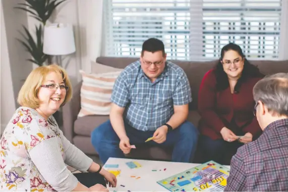  ?? AVI URBAN ?? Mike Hopkins and Melanie Boudreau, centre, play Monopoly with Melanie’s parents Nicole and James Boudreau. They’ll soon be neighbours at Carrington Urban Terraces.