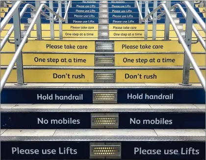  ?? ?? SIGNS OF THE TIMES: The staircase at London’s Paddington Station plastered with needless fusspot instructio­ns