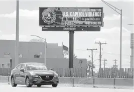  ?? STOCKER/SOUTH FLORIDA SUN SENTINEL SUSAN ?? A digital billboard asking the public to report tips related to the U.S. Capitol violence to the FBI stands along Interstate 95 near Hallandale Beach Boulevard in Hallandale on Tuesday.