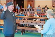  ?? SEAN D. ELLIOT/THE DAY ?? Mark Waters takes his oath Monday from Norwich City Clerk Betsy Barrett as the new director of safety and training for the Norwich Fire Department. Waters comes to Norwich after a 20-year career in New London.