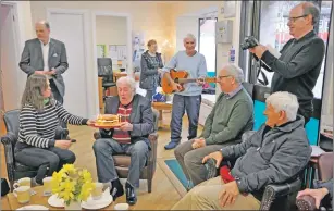  ??  ?? Murdo blows out his 70th birthday cake at the Dove Centre's men's support group.