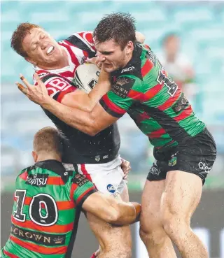  ??  ?? Roosters forward Dylan Napa is crunched by Rabbitoh Angus Crichton.