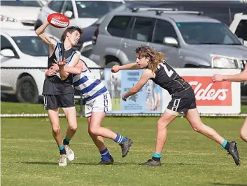  ?? ?? Yarragon’s Matthew Armstrong picks up the ball as Neerim’s Blake MacDonald tackles him in the under 16s.