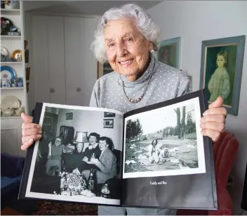  ?? WAYNE CUDDINGTON ?? Former city councillor Toddy Kehoe, seen with a photo album of memories, turned 100 years old in October. “I feel totally blessed because I’ve had such a good life,” she says.