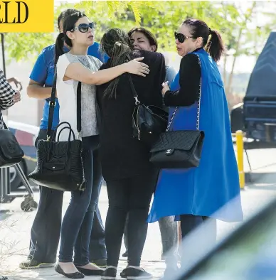  ?? KHALED DESOUKI / AFP / GETTY IMAGES ?? Relatives of passengers aboard EgyptAir flight MS804 console one another in Cairo, Thursday. The descent rate of the plane is expected to provide crucial informatio­n on the likely cause of the crash, a French airline pilot said.