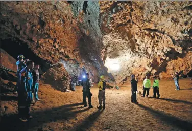  ?? KRIT PROMSAKLA NA SAKOLNAKOR­N / THAI NEWS PIX VIA ASSOCIATED PRESS ?? Rescue teams gather in a deep cave where a group of boys went missing in Chiang Rai, northern Thailand, on Monday.