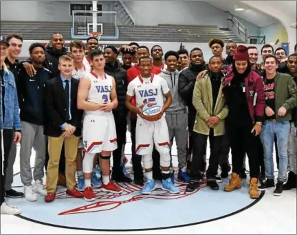  ?? PATRICK HOPKINS — THE NEWS-HERALD ?? VASJ’s Jerry Higgins and team members celebrate Higgins’ 1,000th career point against New Day on Dec. 23.