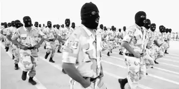  ?? / AFP photo ?? Soldiers from the self-styled army of Khalifa Haftar take part in a military parade in the eastern city of Benghazi during which Haftar announced a military offensive to take from ‘terrorists’ the city of Derna, the only part of eastern Libya outside...