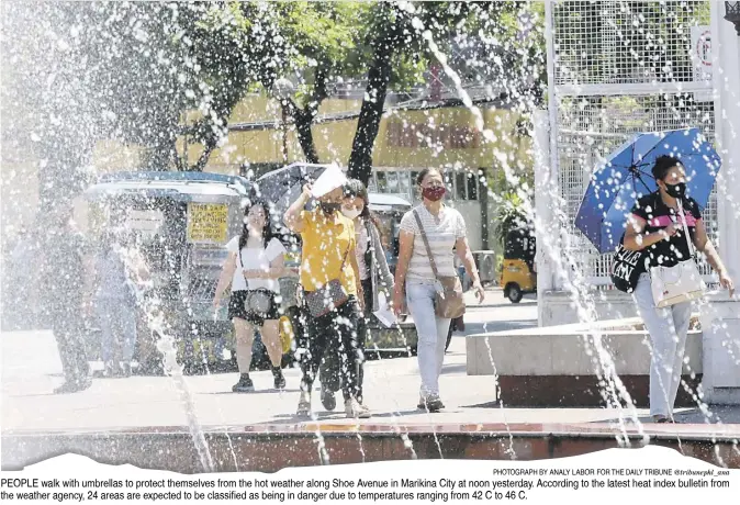  ?? PHOTOGRAPH BY ANALY LABOR FOR THE DAILY TRIBUNE @tribunephl_ana ?? PEOPLE walk with umbrellas to protect themselves from the hot weather along Shoe Avenue in Marikina City at noon yesterday. According to the latest heat index bulletin from the weather agency, 24 areas are expected to be classified as being in danger due to temperatur­es ranging from 42°C to 46°C.