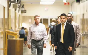  ?? Lea Suzuki / The Chronicle ?? James Steinle (left), father of Kate Steinle, walks through a corridor at the Hall of Justice. He offered emotional testimony on the first day of the murder trial over the killing of his daughter.