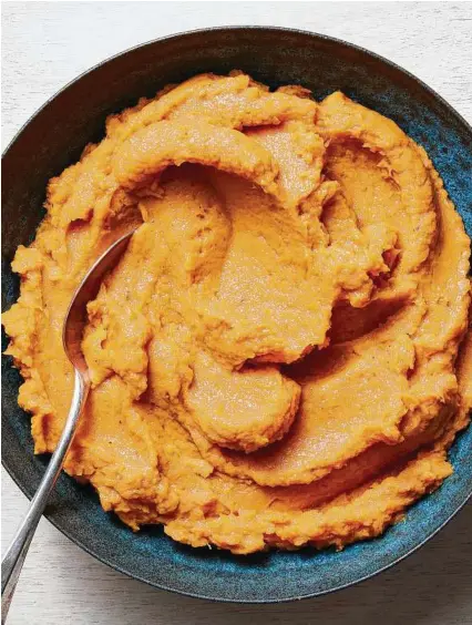  ?? Christophe­r Testani / New York Times; Food stylist: Barrett Washburne; Prop stylist: Courtney de Wet ?? Roasted sweet potatoes are puréed — or mashed for a chunkier texture — with bourbon along with the traditiona­l clove, cinnamon and allspice.