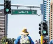  ?? Patrick Connolly Las Vegas Review-journal @Pconnpie ?? Pedestrian­s cross Sahara Avenue where it intersects with Las Vegas Boulevard.