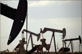  ?? THE ASSOCIATED PRESS ?? Pump jacks work a field near Lovington, N.M. Oil industry and environmen­tal groups say they are not in favor of the EPA’s proposed rule plugging methane leaks at facilities.