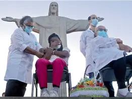  ?? AP ?? Erezinha da Conceicao (L) and Dulcinea da Silva Lopes(R) become the first women to receive the Covid-19 vaccine produced by China's Sinovac Biotech Ltd, during the start of the vaccinatio­n program in Rio de Janeiro, Brazil on Monday. —