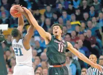  ?? ELISE AMENDOLA/ASSOCIATED PRESS ?? Zach Smith of Texas Tech stretches his arm to defend Villanova’s Dhamir Cosby-Roundtree during the first half of Sunday’s East Regional final in Boston.