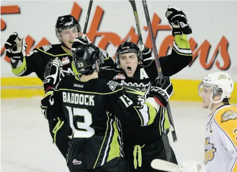  ?? LARRY WONG/EDMONTON JOURNAL ?? Edmonton Oil Kings teammates Ashton Sautner, left, and Brandon Baddock celebrate Riley Kieser’s goal as Brandon Wheat Kings defenceman Ryan Pulock skates by during a Western Hockey League game on Tuesday at Rexall Place.