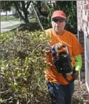  ??  ?? Landscaper Felipe Rojas Orta works in a client’s Monroevill­e yard. He applied for PPP funds with the chamber’s assistance.