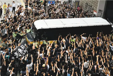  ?? Anthony Wallace / AFP via Getty Images ?? Demonstrat­ors in Hong Kong surround a prison bus transporti­ng leading independen­ce activist Edward Leung.