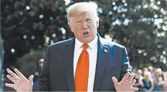  ?? EVAN VUCCI/AP ?? President Trump talks to reporters Friday on the South Lawn of the White House before flying to his New Jersey golf club.