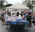  ??  ?? Booths have been set up for sales along Broadway Avenue during Fringe fest.