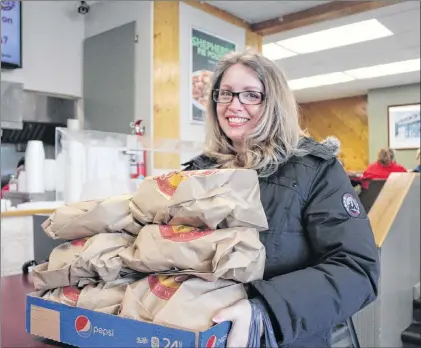 ?? JUANITA MERCER/THE TELEGRAM ?? Krista Bennett picked up 15 orders of fish ‘n’ chips for all of her co-workers at Lawton’s on Campbell Avenue.