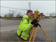  ?? ZACHARY SRNIS — THE MORNING JOURNAL ?? Tom Snezek, owner of Snezek and Associates, uses a total station to map out the land for the Carlisle Township Veterans Memorial.