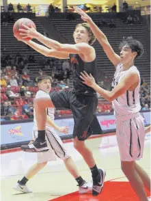  ?? GREG SORBER/JOURNAL ?? Artesia’s Cody Smith, left, drives past Capital’s Seth Arroyos for a basket during their quarterfin­al game.