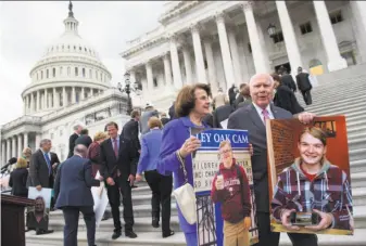  ?? Saul Loeb / AFP / Getty Images ?? Sen. Dianne Feinstein (front left) and Vermont Sen. Patrick Leahy stand with other Democratic senators as they hold photos of people who would lose health care coverage under the GOP bill.