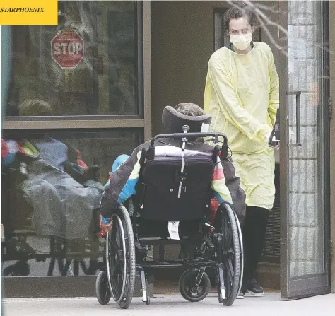  ?? STAN BEHAL / POSTMEDIA NEWS ?? A staff member helps a patient back into the Pinecrest Nursing Home in Bobcaygeon, Ont., northeast of Toronto, where a total of nine residents
have died of the coronaviru­s, including seven on the weekend. Long term care homes have proven to be hot spots of the pandemic in Canada.