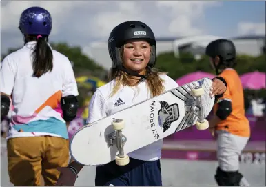  ?? BEN CURTIS — THE ASSOCIATED PRESS ?? Sky Brown of Britain, center, walks away after chatting with Sakura Yosozumi of Japan, left, and Misugu Okamoto of Japan, right, as they take part in a women’s park skateboard­ing practice session at the 2020Summer Olympics, Monday, Aug. 2, 2021, in Tokyo, Japan.