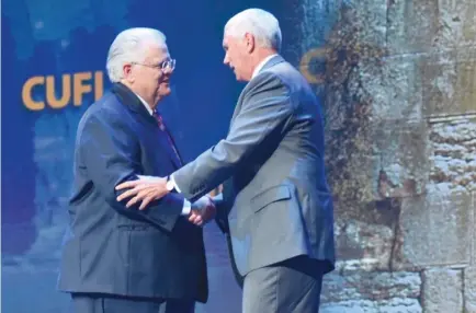  ?? (Kasim Hafeez/CUFI) ?? PASTOR JOHN HAGEE (left) founder of Christians United for Israel, shaking hands with Vice President Mike Pence at CUFI’s annual conference last week.