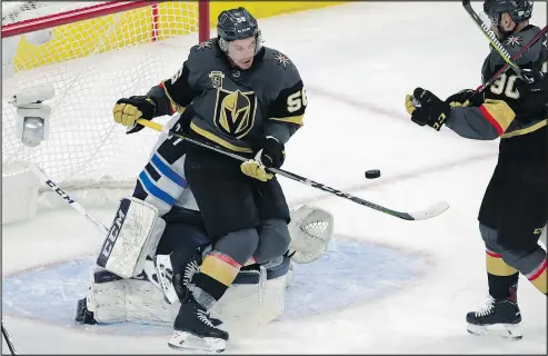  ?? ISAAC BREKKEN/GETTY IMAGES ?? Keegan Kolesar of the Golden Knights attempts to deflect a shot in front of Jets goaltender Connor Hellebuyck during the first period of Game 3 last night.